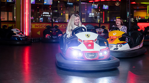 Two girls creating memories having fun on dodgems at namco funscape 