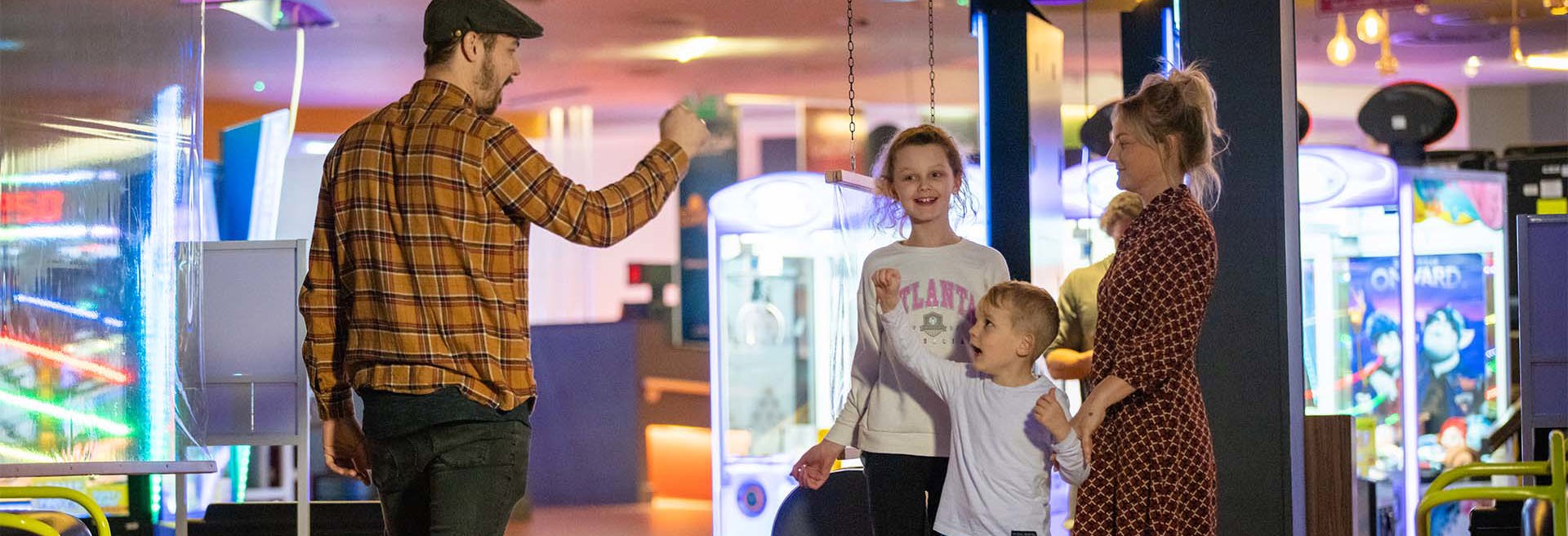 family celebrating whilst bowling at namco funscape braintree