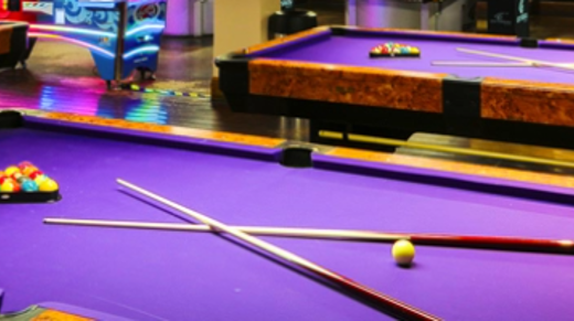 A group of purple pool tables