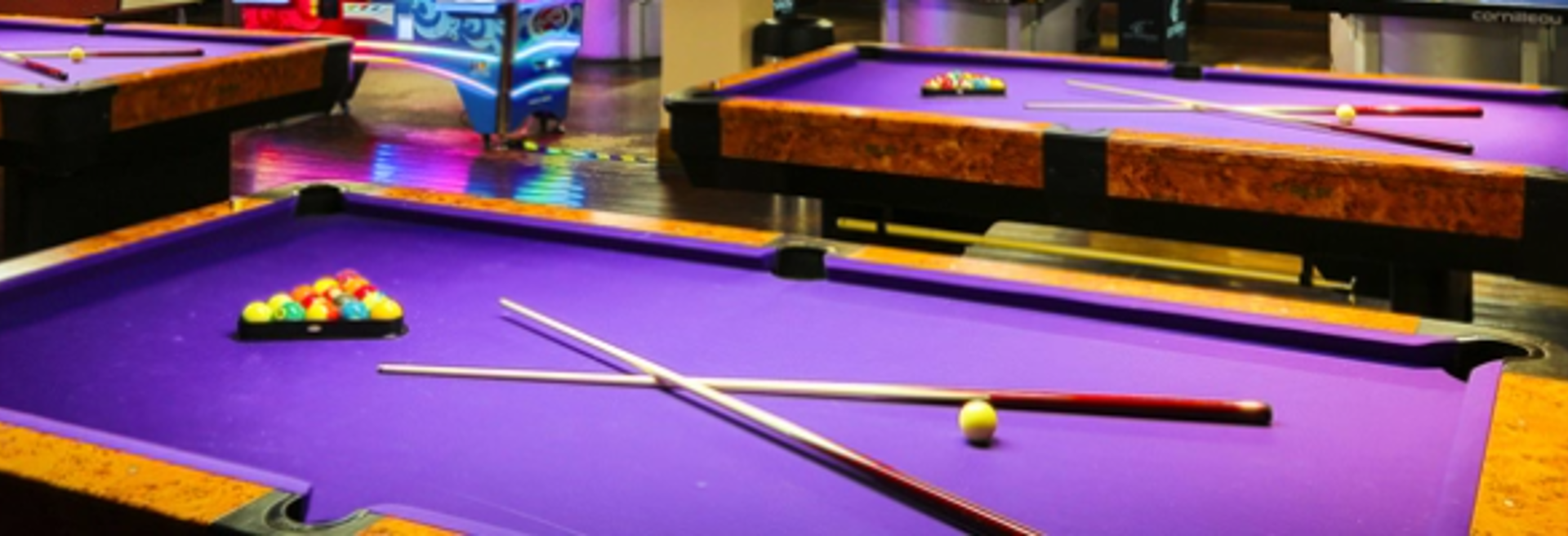 A group of purple pool tables